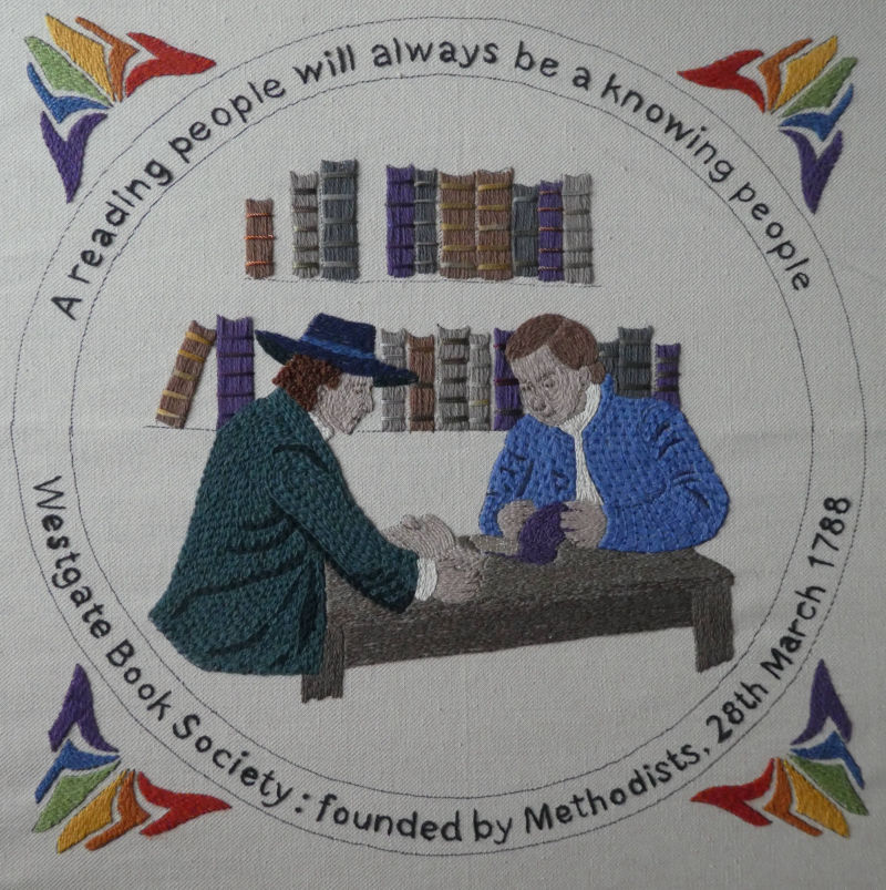 Needlework showing two men in 18th century dress, with bookshelves